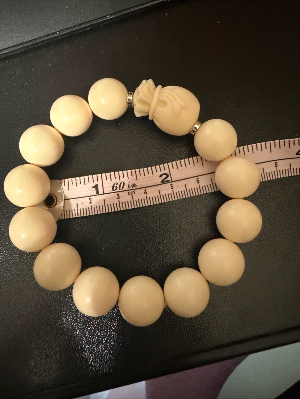 Cream tagua nut Bead Stretch Bracelet with Carved Accent money bag charm